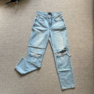 High waisted light wash jeans with rips at knees